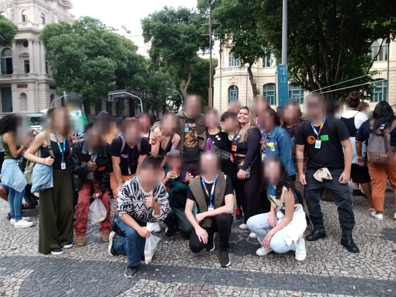 Maria Rejane sorrindo no meio de um grupo grande, na rua, num ato da luta antimanicomial; o rosto das outras pessoas está borrado